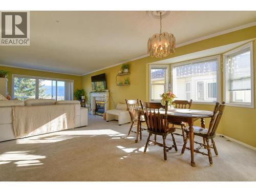 7 500 Wotzke Drive, Williams Lake, BC - Indoor Photo Showing Dining Room With Fireplace