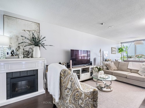 601-50 Eglinton Avenue W, Mississauga, ON - Indoor Photo Showing Living Room With Fireplace