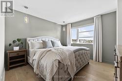 Serene primary bedroom with hardwood flooring - 