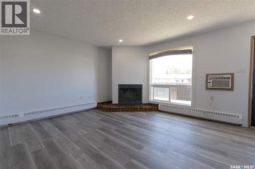 209 2931 Harding Street, Regina, SK - Indoor Photo Showing Living Room With Fireplace