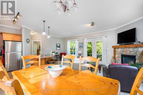 114 - 184 Snowbridge Way, Blue Mountains, ON - Indoor Photo Showing Dining Room With Fireplace
