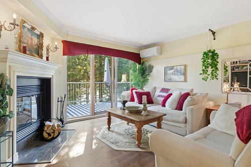 Living room - 215-778 Rue Principale, Saint-Sauveur, QC - Indoor Photo Showing Living Room With Fireplace