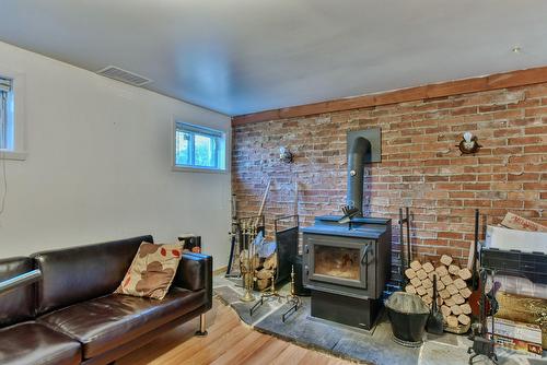Family room - 344 Rue Mitchell, Lachute, QC - Indoor With Fireplace