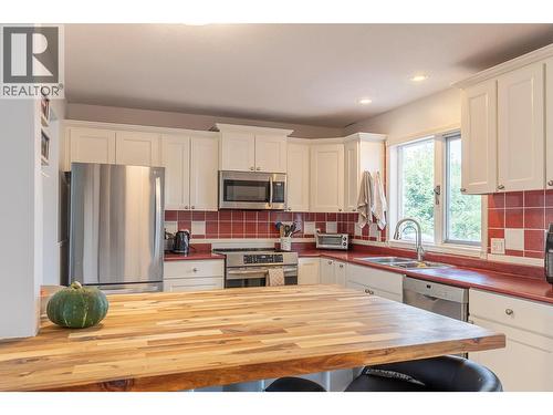 Kitchen island looking into kitchen - 2401 40 Avenue, Vernon, BC - Indoor Photo Showing Kitchen With Double Sink
