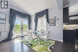 Dining area featuring french doors, vaulted ceiling, and dark wood-style floors - 