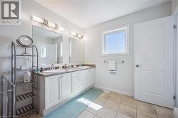 Full bath featuring double vanity and tile patterned flooring - 