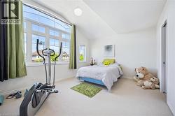 Bedroom featuring lofted ceiling and carpet floors - 