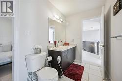 Bathroom featuring ensuite bath, vanity, and tile patterned floors - 