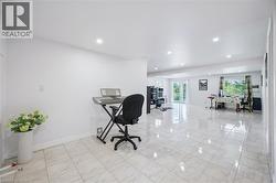 Home office featuring recessed lighting and light marble finish flooring - 