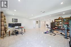 Office with recessed lighting and marble look tiles - 