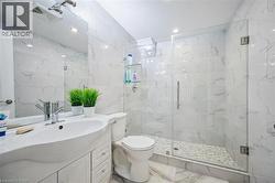 Full bath with a marble finish shower, vanity, tile walls, marble finish floors, and recessed lighting - 