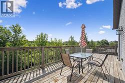 Wooden deck featuring outdoor dining area - 