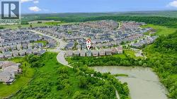 Aerial view of property's location featuring a nearby body of water and nearby suburban area - 