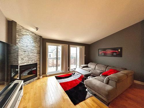 Living room - 403-701 Mtée Des Pionniers, Terrebonne (Lachenaie), QC - Indoor Photo Showing Living Room With Fireplace