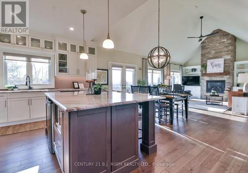 Open concept living with stunning treed view! - 20 Morgan Drive, Oro-Medonte, ON - Indoor Photo Showing Kitchen With Fireplace With Upgraded Kitchen