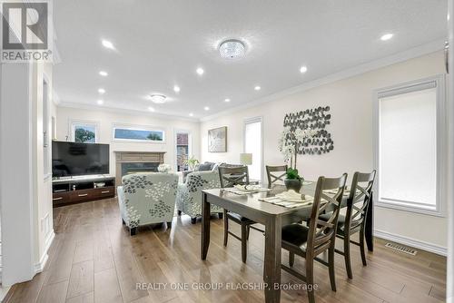 1128 Knotty Pine Grove, Mississauga, ON - Indoor Photo Showing Dining Room With Fireplace
