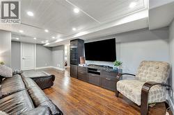 Living room with recessed lighting and dark wood finished floors - 