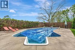 View of swimming pool featuring a fenced backyard and a patio area - 