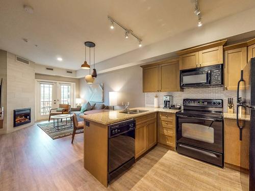 115Cd-1200 Rancher Creek Road, Osoyoos, BC - Indoor Photo Showing Kitchen With Fireplace With Double Sink