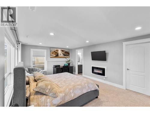 13709 Nash Drive, Coldstream, BC - Indoor Photo Showing Bedroom With Fireplace