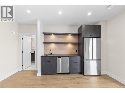 Wet bar in lower level rec room. - 4964 Bucktail Lane, Kelowna, BC - Indoor Photo Showing Kitchen
