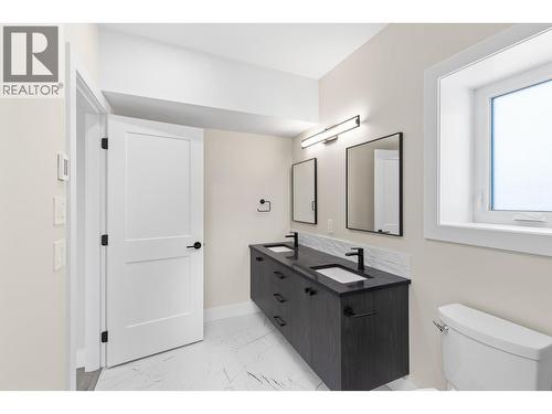 Lower level washroom with double vanity - 4964 Bucktail Lane, Kelowna, BC - Indoor Photo Showing Bathroom