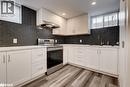 Kitchen featuring healthy amount of natural light, stainless steel electric range oven, backsplash, white cabinets, and recessed lighting - 22 St James Street Unit# C, Brantford, ON  - Indoor Photo Showing Kitchen With Upgraded Kitchen 
