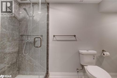 Full bath with a marble finish shower and toilet - 22 St James Street Unit# C, Brantford, ON - Indoor Photo Showing Bathroom