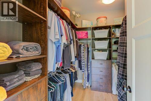 Primary bedroom walk in closet - 425 Audubon Court, Kelowna, BC - Indoor With Storage