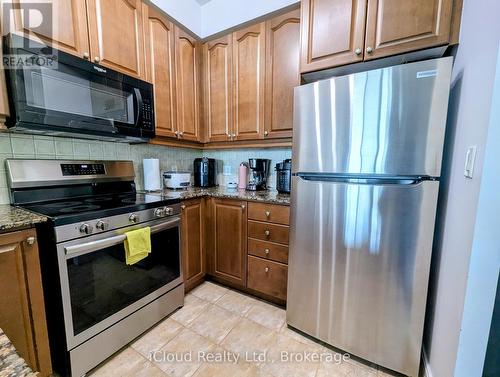 Kitchen with Stainless Steel Fridge - 1010 - 90 Absolute Avenue, Mississauga, ON - Indoor Photo Showing Kitchen