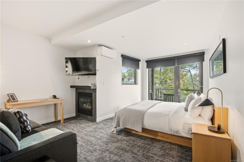 302-596 Marine Dr, Ucluelet, BC - Indoor Photo Showing Bedroom With Fireplace