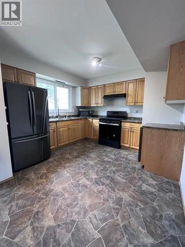 84 5550 Simpson Trail, Fort Nelson, BC - Indoor Photo Showing Kitchen