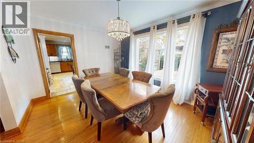 Dining room featuring light wood-style floors, a chandelier, and crown molding - 113 Edmund Road, Kitchener, ON - Indoor Photo Showing Dining Room