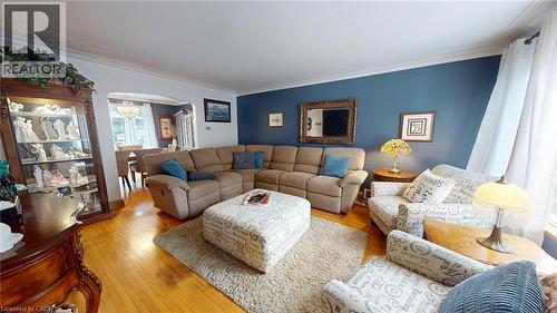 Living room featuring arched walkways, hardwood / wood-style floors, ornamental molding, and a chandelier - 113 Edmund Road, Kitchener, ON - Indoor Photo Showing Living Room