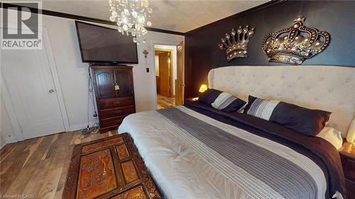 Bedroom featuring a chandelier, crown molding, and wood finished floors - 113 Edmund Road, Kitchener, ON - Indoor Photo Showing Bedroom