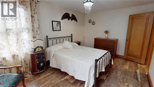 Bedroom with wood finished floors and a chandelier - 113 Edmund Road, Kitchener, ON - Indoor Photo Showing Bedroom