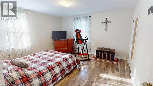 Bedroom with hardwood / wood-style flooring and baseboards - 113 Edmund Road, Kitchener, ON - Indoor Photo Showing Bedroom