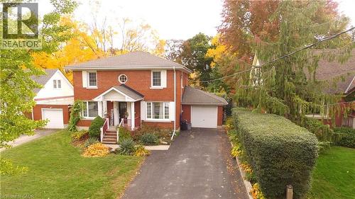 Colonial home with a front lawn, brick siding, driveway, and a garage - 113 Edmund Road, Kitchener, ON - Outdoor With Facade