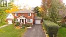 Colonial home with a front lawn, brick siding, driveway, and a garage - 113 Edmund Road, Kitchener, ON  - Outdoor With Facade 