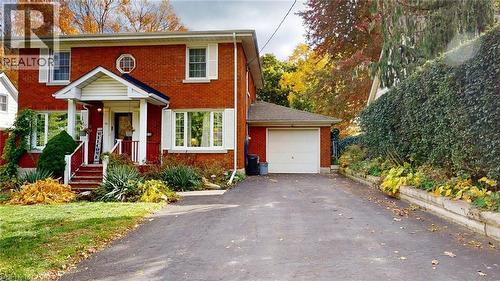 Colonial house with driveway, brick siding, and a garage - 113 Edmund Road, Kitchener, ON - Outdoor With Facade