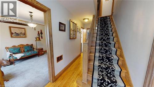 Stairway featuring wood-type flooring and baseboards - 113 Edmund Road, Kitchener, ON - Indoor Photo Showing Other Room