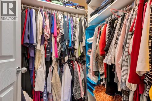 Primary bedroom walk in closet - 393 Mccarren Avenue, Kelowna, BC - Indoor With Storage