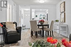 Open-concept dining area with view into a kitchen - 