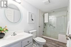 Clean bath with walk-in shower and storage space - 