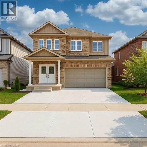 Craftsman-style home with board and batten siding, concrete driveway, a porch, stone siding, and an attached garage - 19 Sassafras Street Unit# Lower, Kitchener, ON - Outdoor With Facade