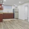 Kitchen featuring freestanding refrigerator, light wood-type flooring, recessed lighting, tasteful backsplash, and light stone countertops - 19 Sassafras Street Unit# Lower, Kitchener, ON  - Indoor 