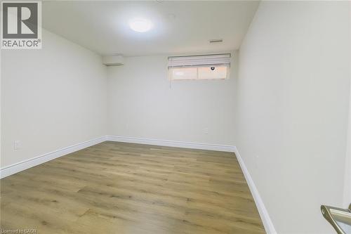 Unfurnished room featuring wood finished floors and baseboards - 19 Sassafras Street Unit# Lower, Kitchener, ON - Indoor Photo Showing Other Room