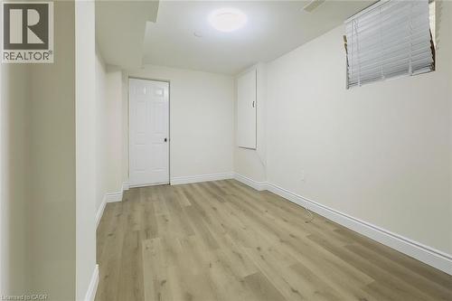 Unfurnished room featuring light wood-style floors and baseboards - 19 Sassafras Street Unit# Lower, Kitchener, ON - Indoor Photo Showing Other Room