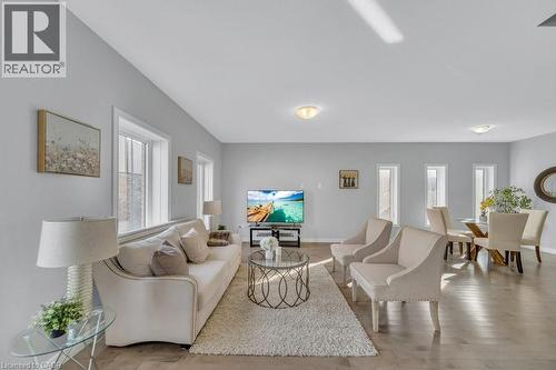 Living room featuring plenty of natural light and light wood finished floors - 43 Sugar Trail, Kitchener, ON - Indoor Photo Showing Living Room