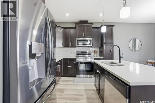 17 600 Maple Crescent, Warman, SK - Indoor Photo Showing Kitchen With Stainless Steel Kitchen With Double Sink With Upgraded Kitchen